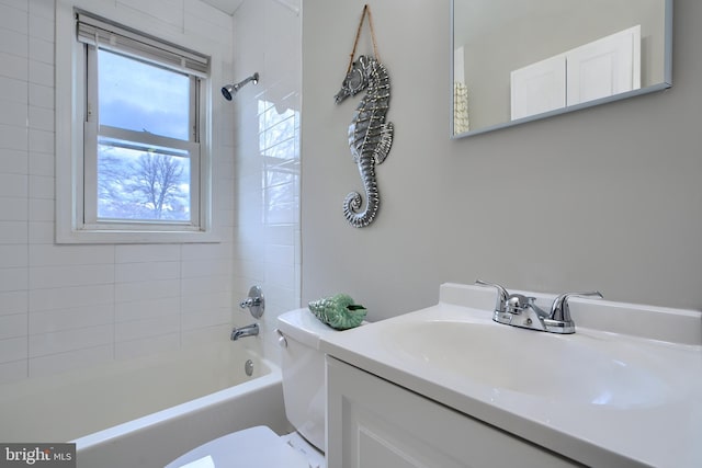 bathroom featuring toilet, vanity, and shower / bathing tub combination