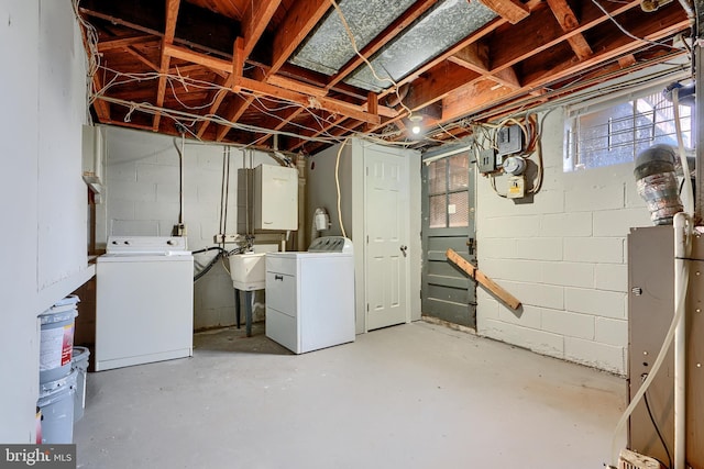 basement with washer and clothes dryer and a sink