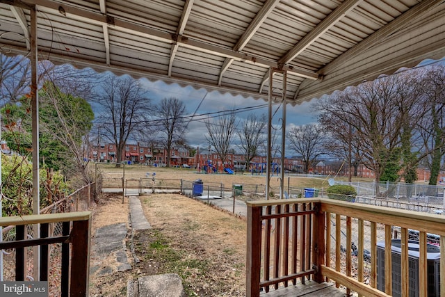 view of yard with cooling unit, a playground, and fence