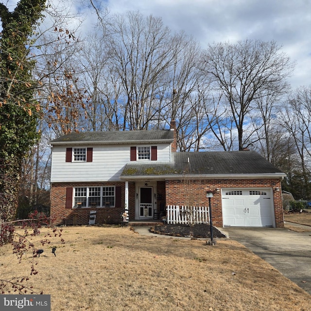 view of front of property featuring brick siding, a chimney, covered porch, a garage, and driveway