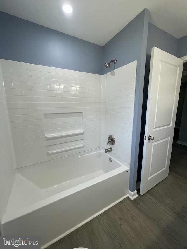 bathroom featuring shower / washtub combination and wood finished floors