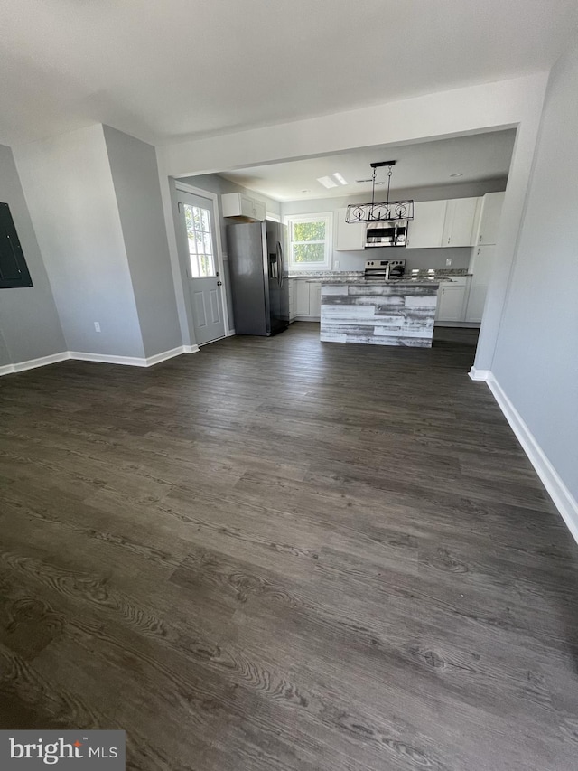 interior space with dark wood finished floors and baseboards