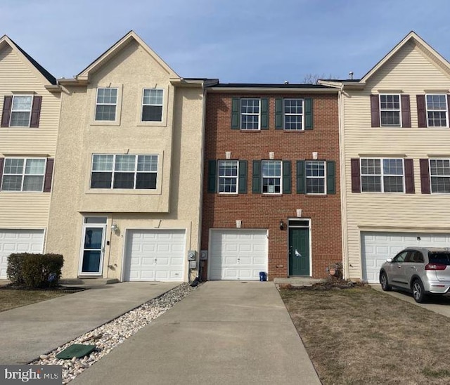 view of property featuring driveway and an attached garage