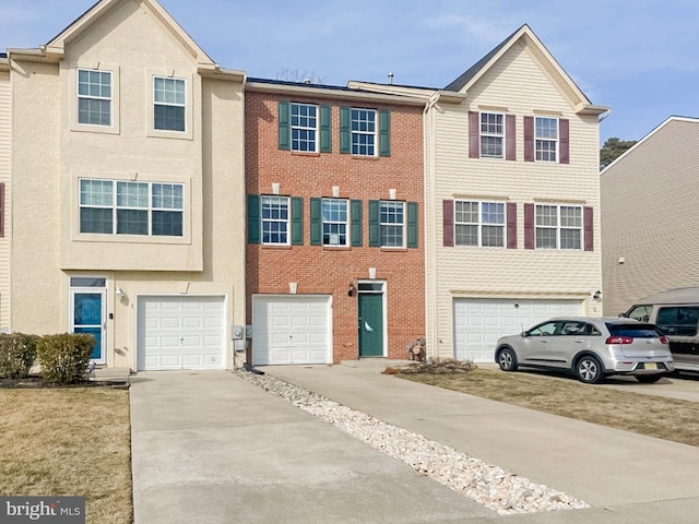 multi unit property with concrete driveway and an attached garage