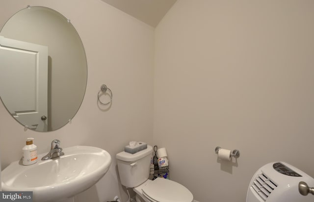 bathroom featuring toilet and a sink