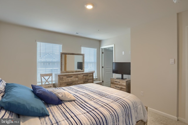 carpeted bedroom with visible vents and baseboards