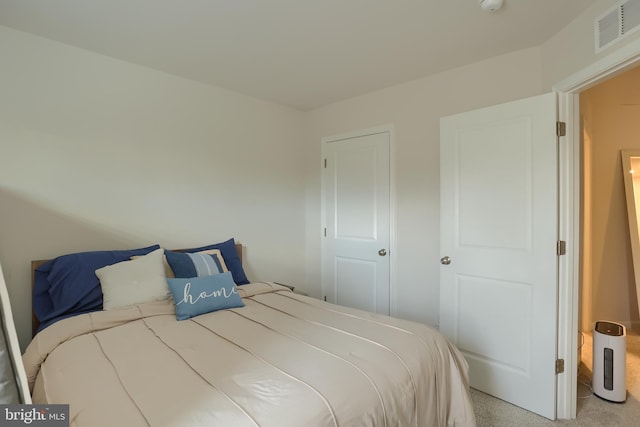 bedroom with visible vents and light colored carpet