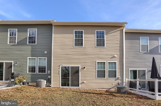 rear view of house with central AC unit