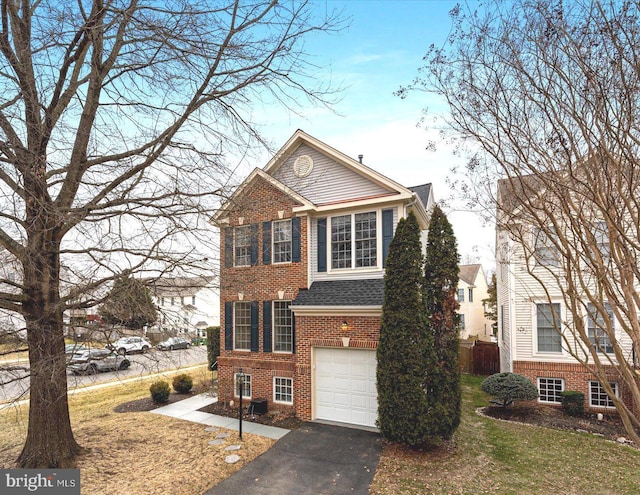 view of front of home with brick siding, an attached garage, a front lawn, roof with shingles, and driveway