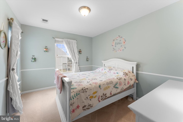 bedroom with visible vents, baseboards, and light colored carpet