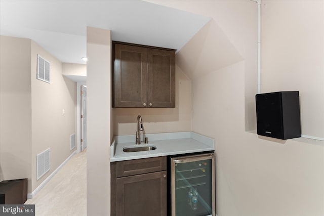 bar with a sink, visible vents, and wine cooler