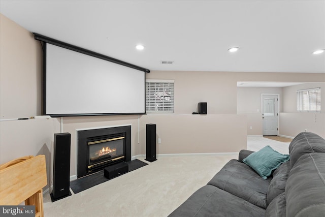 cinema featuring visible vents, baseboards, a fireplace with flush hearth, carpet floors, and recessed lighting