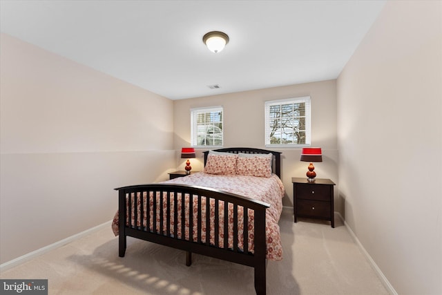 bedroom featuring visible vents, baseboards, and carpet