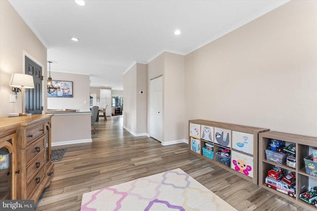 game room with recessed lighting, crown molding, baseboards, and wood finished floors