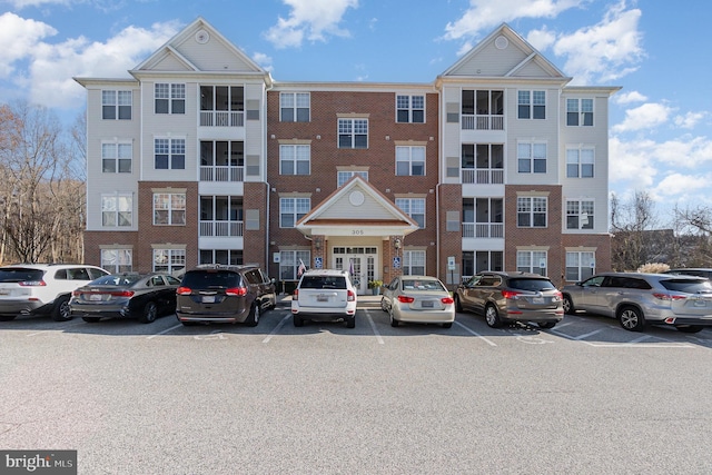 view of building exterior with uncovered parking