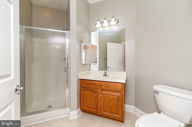 bathroom featuring toilet, a shower stall, baseboards, and vanity