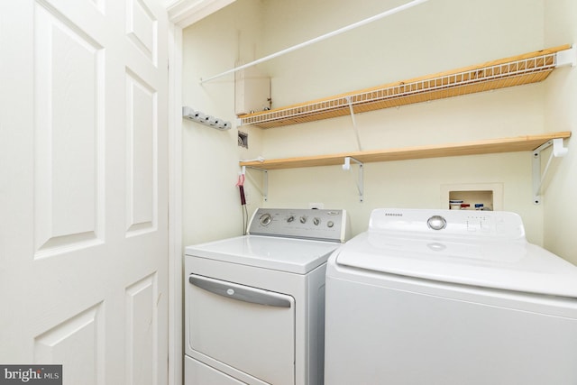 laundry room with laundry area and washing machine and clothes dryer