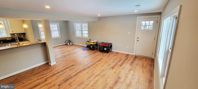 foyer entrance featuring light wood finished floors, recessed lighting, visible vents, and baseboards