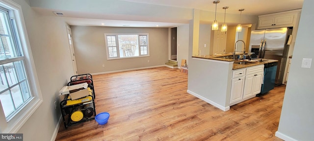 kitchen with light wood-type flooring, visible vents, dishwasher, and stainless steel fridge with ice dispenser