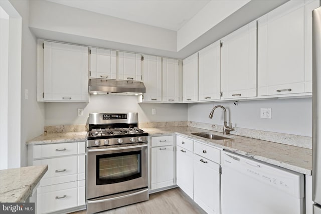 kitchen with under cabinet range hood, a sink, white cabinets, stainless steel gas range, and dishwasher