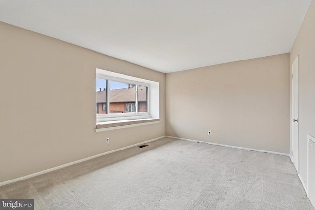 unfurnished room with baseboards, visible vents, and carpet flooring