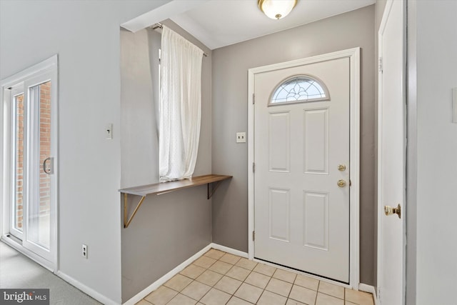 entrance foyer featuring light tile patterned flooring and baseboards