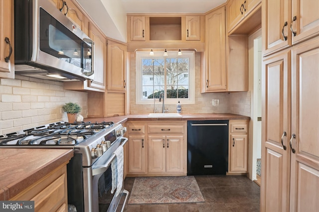 kitchen featuring tasteful backsplash, light countertops, light brown cabinetry, appliances with stainless steel finishes, and a sink