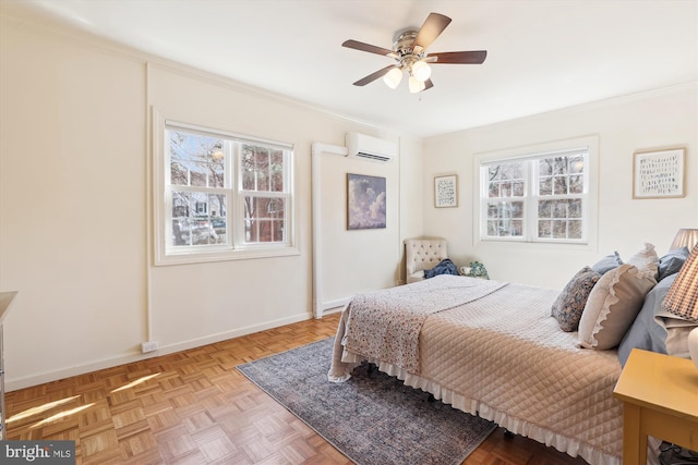 bedroom featuring ornamental molding, a wall mounted air conditioner, ceiling fan, and baseboards