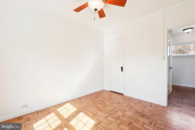 unfurnished bedroom featuring ceiling fan, ornamental molding, and baseboards