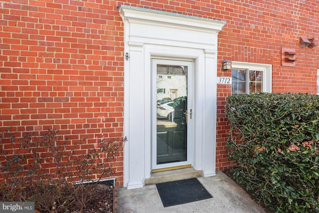 property entrance with brick siding