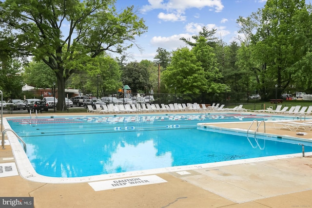 pool featuring a patio and fence