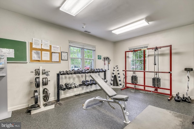 exercise room with visible vents and baseboards