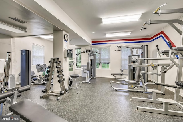 exercise room with baseboards and visible vents