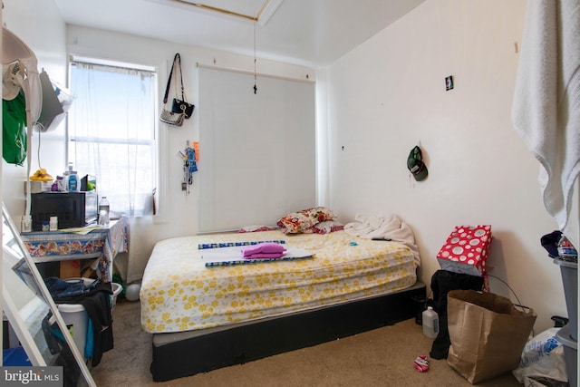 carpeted bedroom featuring attic access