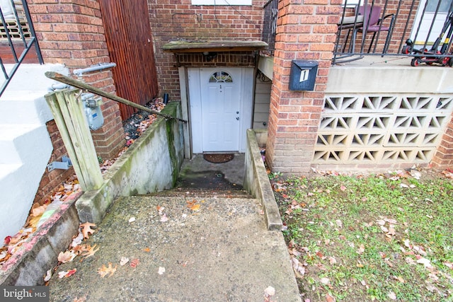 entrance to property with brick siding