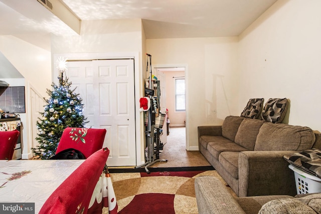 carpeted living area with visible vents and baseboards