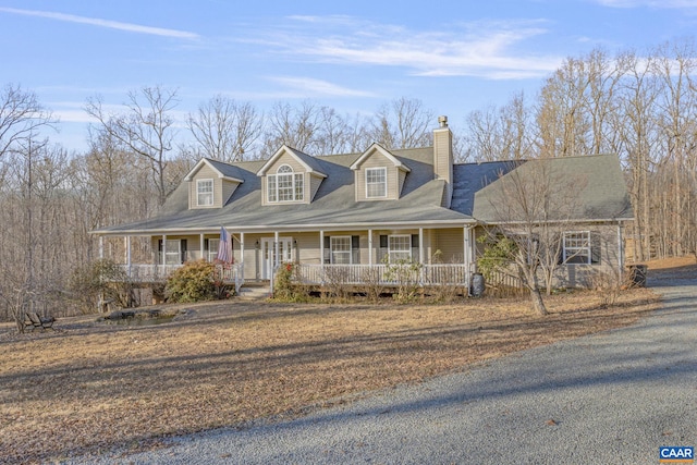 view of front of house featuring covered porch and a chimney