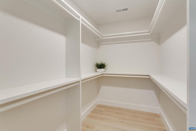 walk in closet featuring visible vents and light wood finished floors