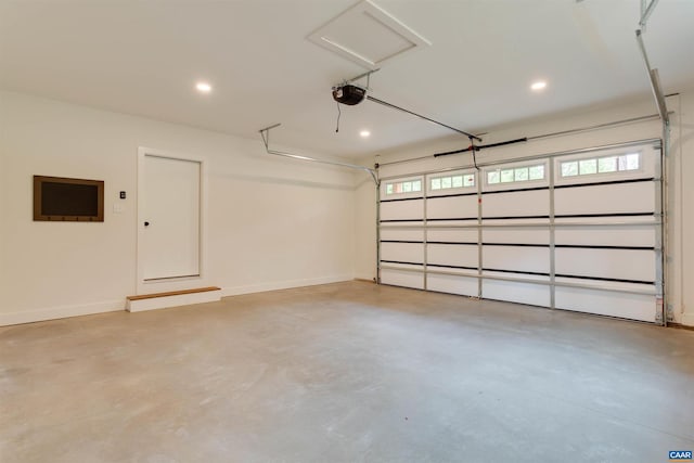 garage with a garage door opener, recessed lighting, and baseboards