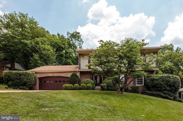 view of front facade featuring a garage, brick siding, driveway, and a front yard