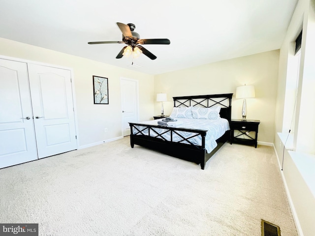 bedroom featuring carpet floors, visible vents, and baseboards