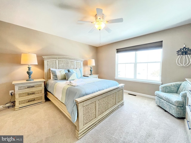 carpeted bedroom featuring visible vents, ceiling fan, and baseboards