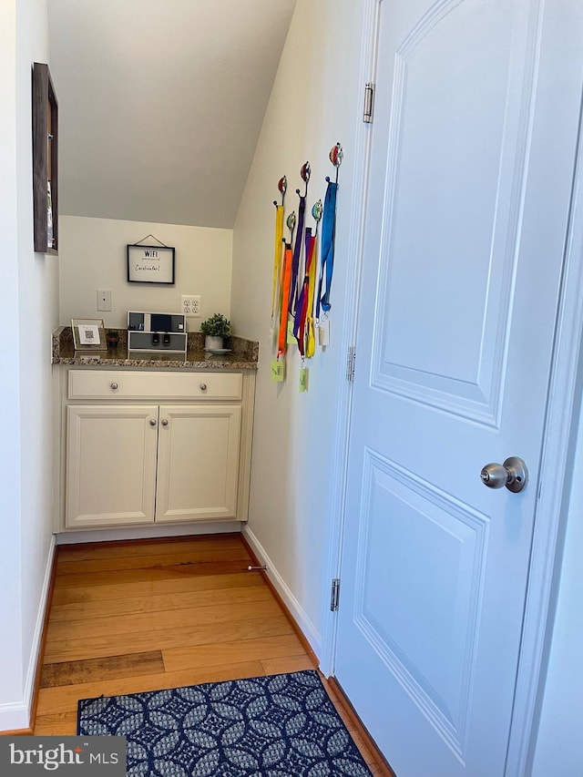 entryway featuring light wood-style flooring and baseboards