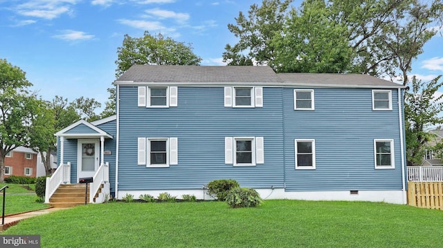 colonial home with crawl space, fence, and a front yard