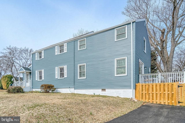 view of home's exterior with a yard and fence