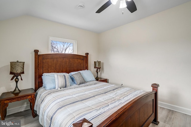 bedroom with light wood-type flooring, ceiling fan, lofted ceiling, and baseboards