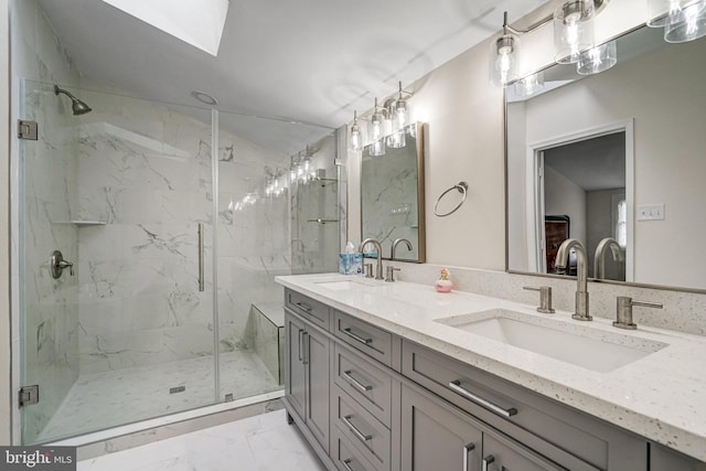 bathroom featuring marble finish floor, a sink, a marble finish shower, and double vanity