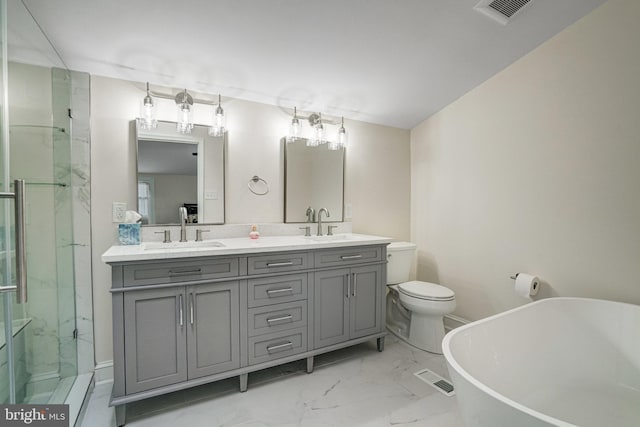 bathroom with marble finish floor, visible vents, a sink, and a freestanding bath