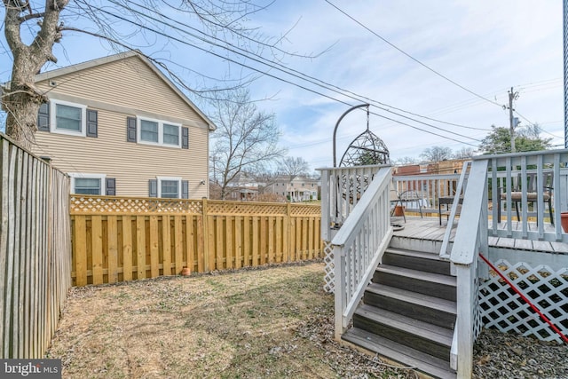 view of yard featuring a fenced backyard and a wooden deck