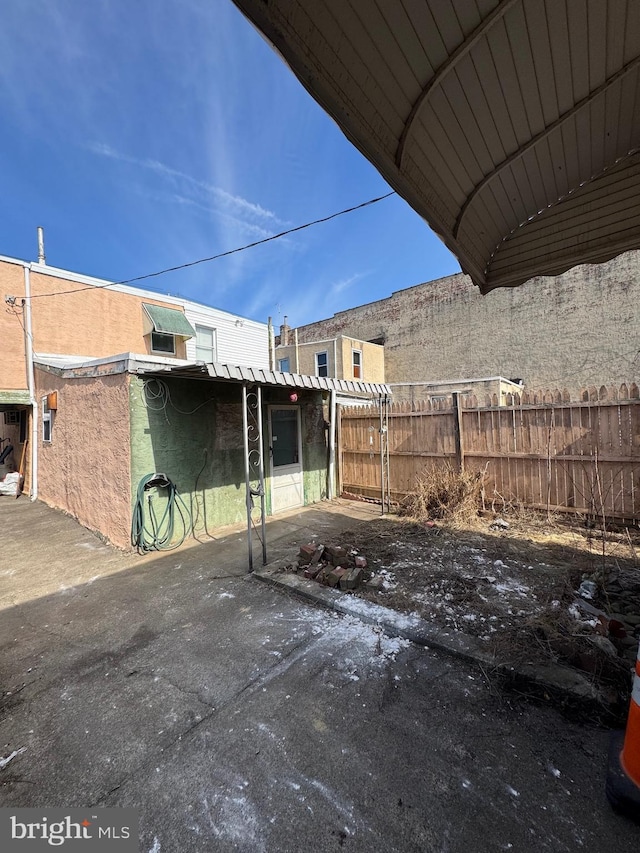 view of patio featuring fence